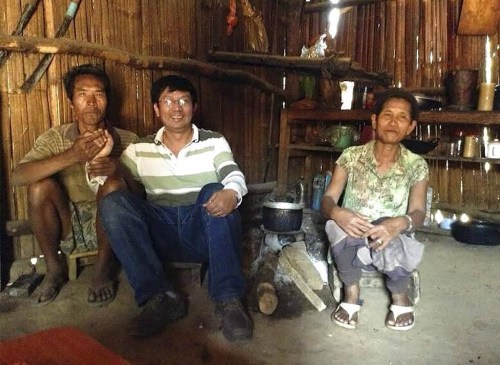 In this undated UGC photo released by Cao Family, Rev. John Sanqiang Cao, center, poses for photo with locals during his missionary work prior to 2017 in Northern Myanmar. The Rev. John Sanqiang Cao was arrested and sentenced to seven years in prison while coming back from a missionary trip in Myanmar. Now back in his hometown of Changsha in southern Hunan province, he is without any legal documentation in his country, unable to access even the most basic services without a Chinese identification. (Cao Family via AP)