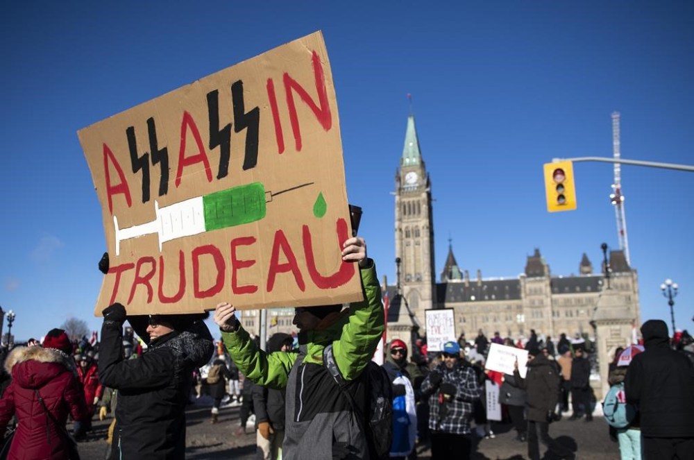 People protest Prime Minister Justin Trudeau and vaccinations during a rally against COVID-19 restrictions on Parliament Hill, Saturday, Jan. 29, 2022. Threats against politicians have become