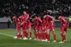 North Korea's players greet their supporters at the end of the FIFA World Cup 2026 and AFC Asian Cup 2027 preliminary joint qualification round 2 match between Japan and North Korea at the National Stadium Thursday, March 21, 2024, in Tokyo. (AP Photo/Eugene Hoshiko)