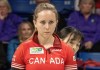 Korea skip Eunji Gin peers around Canada skip Rachel Homan while standing in the house in World Women's Curling Championship playoff action in Sydney, N.S. on Saturday, March 23, 2024. THE CANADIAN PRESS/Frank Gunn