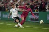 D.C. United's Jackson Hopkins, left, tackles St. Louis City's Celio Pompeu during the second half of an MLS soccer match Saturday, March 23, 2024, in St. Louis. (AP Photo/Jeff Roberson)