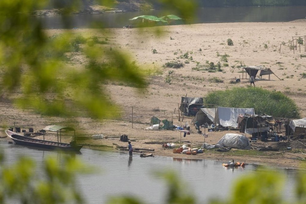 A camp for internally displaced people in Myanmar is seen across the Moei river from Mae Sot, Tak province Thailand Monday, March 25, 2024. Thailand delivered its first batch of humanitarian aid to war-torn Myanmar sending ten trucks over the border from the northern province of Tak in what they hope will be a continuing effort to ease the plight of millions of people displaced by fighting. (AP Photo/Sakchai Lalit)