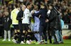 FILE - Real Madrid's Vinicius Junior, center, is restrained as he argues with Valencia's Selim Amallah at the end of the La Liga soccer match between Valencia and Real Madrid at the Mestalla Stadium in Valencia, Spain, Saturday, March 2, 2024. Vinícius Júnior clenched his right fist and raised it high above his head after scoring at Mestalla Stadium, posing for a moment so everyone could see him. The symbolic gesture came nearly a year after the Real Madrid forward was on that same field with tears in his eyes after being racially abused by some Valencia fans. (AP Photo/Jose Breton, File)