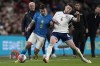 England's Declan Rice vies for the ball with Brazil's Bruno Guimaraes, left, during a friendly soccer match between England and Brazil at Wembley Stadium in London, Saturday, March 23, 2024. (AP Photo/Alastair Grant)