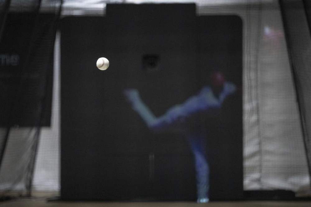 The Trajekt Arc pitching machine is demonstrated during the Major League Baseball winter meetings Wednesday, Dec. 6, 2023, in Nashville, Tenn. Trajekt uses data to mimic the way balls spin and break from big league pitchers and has for the first time been approved by Major League Baseball for in-game use this year in batting cages. (AP Photo/George Walker IV)