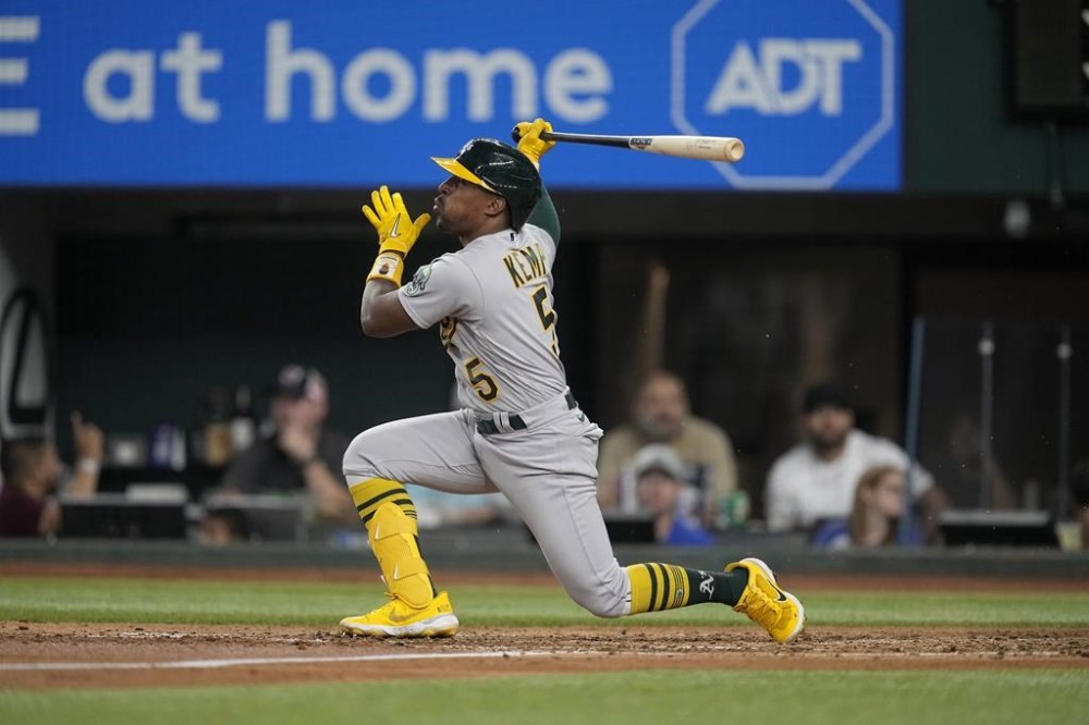 FILE - Oakland Athletics' Tony Kemp follows through on a swing during a baseball game against the Texas Rangers, Saturday, Sept. 9, 2023, in Arlington, Texas. Kemp agreed to a $1 million, one-year contract with the Baltimore Orioles on Tuesday, March 26, 2024, one week after the 32-year-old was released from a minor league deal with the Cincinnati Reds.(AP Photo/Tony Gutierrez, File)