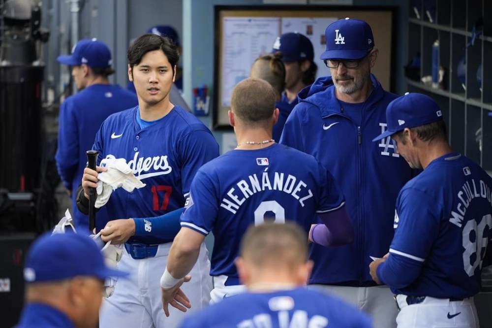 Los Angeles Dodgers' Shohei Ohtani (17) walks across the dugout during the first inning of a spring training baseball game against the Los Angeles Angels Monday, March 25, 2024, in Los Angeles. (AP Photo/Jae C. Hong)
