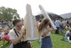 FILE - Reveka Pasternak, of Boston, left, and her sister Tristen, of Philadelphia, right, use pinhole projectors to view a partial solar eclipse, Monday, Aug. 21, 2017, on the campus of Massachusetts Institute of Technology, in Cambridge, Mass. The sisters made the pinhole projectors from cardboard that allow people to safely view the eclipse. (AP Photo/Steven Senne, File)