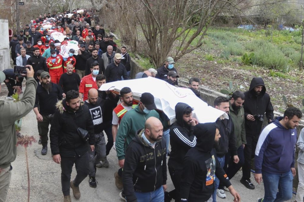 People carry the coffins of paramedics who were killed in an Israeli airstrike, during a funeral procession in Hebbariye village, south Lebanon, Wednesday, March 27, 2024. The Israeli airstrike on a paramedic center linked to a Lebanese Sunni Muslim group killed several people. The strike was one of the deadliest single attacks since violence erupted along the Lebanon-Israel border more than five months ago. (AP Photo/Mohammed Zaatari)