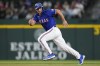 Texas Rangers' Wyatt Langford runs from second to third base on Jared Walsh's RBI single during the second inning of a spring training baseball game against the Boston Red Sox, Monday, March 25, 2024, in Arlington, Texas. (AP Photo/Sam Hodde)