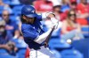 Toronto Blue Jays' Bo Bichette hits a single in the fifth inning of a spring training baseball game against the Philadelphia Phillies Monday, March 4, 2024, in Dunedin, Fla. THE CANADIAN PRESS/AP, Charlie Neibergall