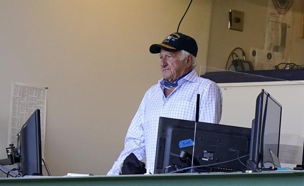 FILE - Milwaukee Brewers broadcaster Bob Uecker stands during the seventh inning of the team's baseball game against the Pittsburgh Pirates on Aug. 30, 2020, in Milwaukee. Uecker will be back behind the microphone when the Brewers play their home-opener Tuesday, April 3, against the Minnesota Twins. How heavy a broadcasting workload the 90-year-old Uecker will have the rest of the season remains uncertain. (AP Photo/Morry Gash, File)