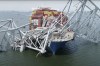 In this image taken from video released by the National Transportation and Safety Board, the cargo ship Dali is stuck under part of the structure of the Francis Scott Key Bridge after the ship hit the bridge, Tuesday, March 26, 2024, in Baltimore. (NTSB via AP)