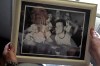 Briana Garton looks at a family photo showing her late brother, Taylor Ware, foreground right, as she talks about his 2019 death, Tuesday, June 6, 2023, at her home near Hale, Mo. “It was like that was his body’s own fault, that it wasn’t the police’s fault,” Garton, said of the autopsy ruling that Ware died of natural causes. (AP Photo/Charlie Riedel)