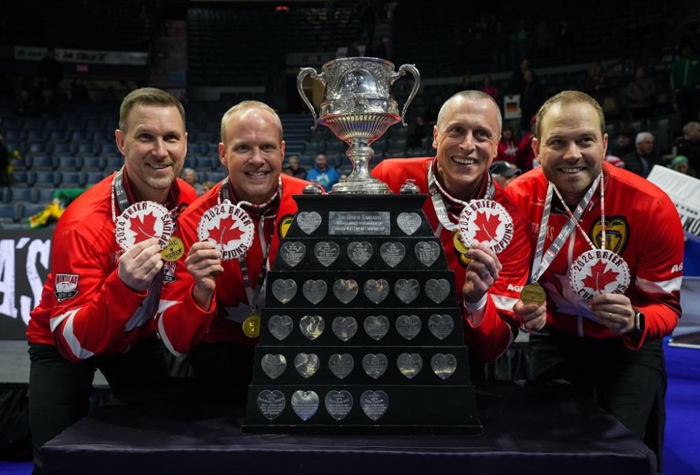 Canada skip Brad Gushue, from left to right, third Mark Nichols, second E.J. Harnden and lead Geoff Walker pose with the Brier Tankard and First Nations beadwork after defeating Saskatchewan in the final at the Brier, in Regina, Sunday, March 10, 2024. THE CANADIAN PRESS/Darryl Dyck