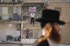 An effigy of Hamas leader Yehya Sinwar hangs off the balcony of an apartment under the sign 