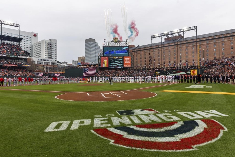The national anthem is performed prior to the first inning of a baseball game between the Baltimore Orioles and the Los Angeles Angels, Thursday, March 28, 2024, in Baltimore. (AP Photo/Julia Nikhinson)