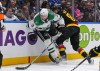 Dallas Stars' Chris Tanev (3) is checked by Vancouver Canucks' Arshdeep Bains (80) during the third period of an NHL hockey game in Vancouver, on Thursday, March 28, 2024. THE CANADIAN PRESS/Darryl Dyck