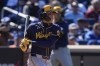 Milwaukee Brewers' Christian Yelich (22) follows through on a single during the fifth inning of a baseball game against the New York Mets Friday, March 29, 2024, in New York. (AP Photo/Frank Franklin II)