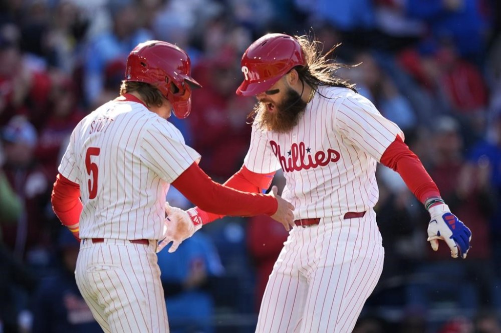Philadelphia Phillies' Brandon Marsh, right, and Bryson Stott celebrate after Marsh's two-run home run against Atlanta Braves pitcher Spencer Strider during the fifth inning of an opening-day baseball game, Friday, March 29, 2024, in Philadelphia. (AP Photo/Matt Slocum)