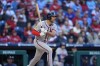 Atlanta Braves' Matt Olson follows through after hitting a three-run double off Philadelphia Phillies pitcher Connor Brogdon during the eighth inning of an opening-day baseball game, Friday, March 29, 2024, in Philadelphia. (AP Photo/Matt Slocum)