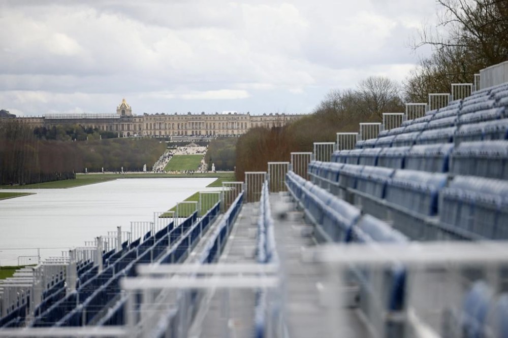 The stands to watch the equestrian sports are seen Friday, March 29, 2024 in the park of the Chateau de Versailles, seen in background, west of Paris. The site will be the venue for equestrian sports at the Paris 2024 Olympic Games. (AP Photo/Thomas Padilla)