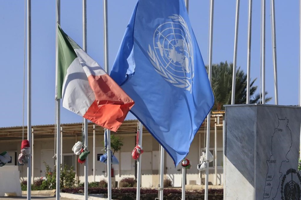 FILE - The United Nations and the Ireland flags fly at half-staff, at the UNIFIL headquarters in the southern Lebanese town of Naqoura, Lebanon, on Dec. 16, 2022 Four United Nations military observers were wounded Saturday while patrolling along the southern Lebanese border after a shell exploded near them, the U.N. peacekeeping mission in southern Lebanon said. The military observers of the United Nations Truce Supervision Organization support the U.N. peacekeeping mission in southern Lebanon, UNIFIL. (AP Photo/Mohammed Zaatari, File)