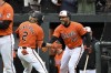 Baltimore Orioles' Gunnar Henderson (2) celebrates his solo home run hit against Los Angeles Angels starting pitcher Griffin Canning with Anthony Santander (25) during the first inning of a baseball game, Saturday, March, 30, 2024, in Baltimore. (AP Photo/Terrance Williams)