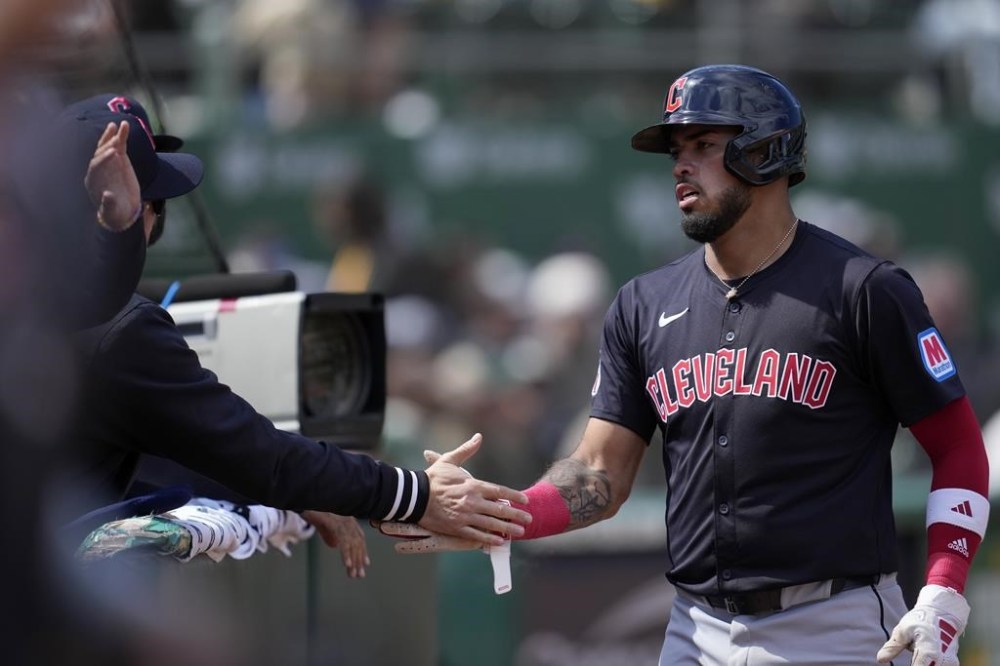 Cleveland Guardians' Gabriel Arias is congratulated by teammates after scoring against the Oakland Athletics during the fourth inning of a baseball game in Oakland, Calif., Saturday, March 30, 2024. (AP Photo/Jeff Chiu)