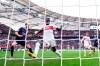 Stuttgart's scorer Serhou Guirassy, second left, scores the opening goal during the Bundesliga soccer match between VfB Stuttgart and 1. FC Heidenheim in Stuttgart, Germany, Sunday, March 31, 2024. (Tom Weller/dpa via AP)