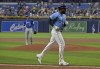 Toronto Blue Jays starter Kevin Gausman, left, watches as Tampa Bay Rays' Randy Arozarena jogs home after hitting a solo home run during the first inning of a baseball game, Sunday, March 31, 2024, in St. Petersburg, Fla. (AP Photo/Steve Nesius)