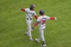 Washington Nationals' Trey Lipscomb, right, hugs CJ Abrams, left, after hitting a solo home run during the seventh inning of a baseball game against the Cincinnati Reds in Cincinnati, Sunday, March 31, 2024. (AP Photo/Aaron Doster)