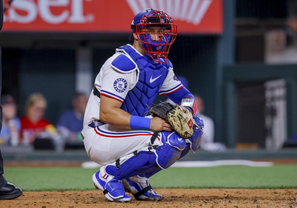 Texas Rangers catcher Andrew Knizner looks to the dugout during the fourth inning of a baseball game against the Chicago Cubs, Sunday, March 31, 2024, in Arlington, Texas. (AP Photo/Gareth Patterson)