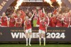 Arsenal's Leah Williamson, centre left, and Kim Little lift the trophy after winning the FA Women's Continental Tyres League Cup Final at Molineux Stadium, Wolverhampton, England, Sunday March 31, 2024. (Nick Potts/PA via AP)