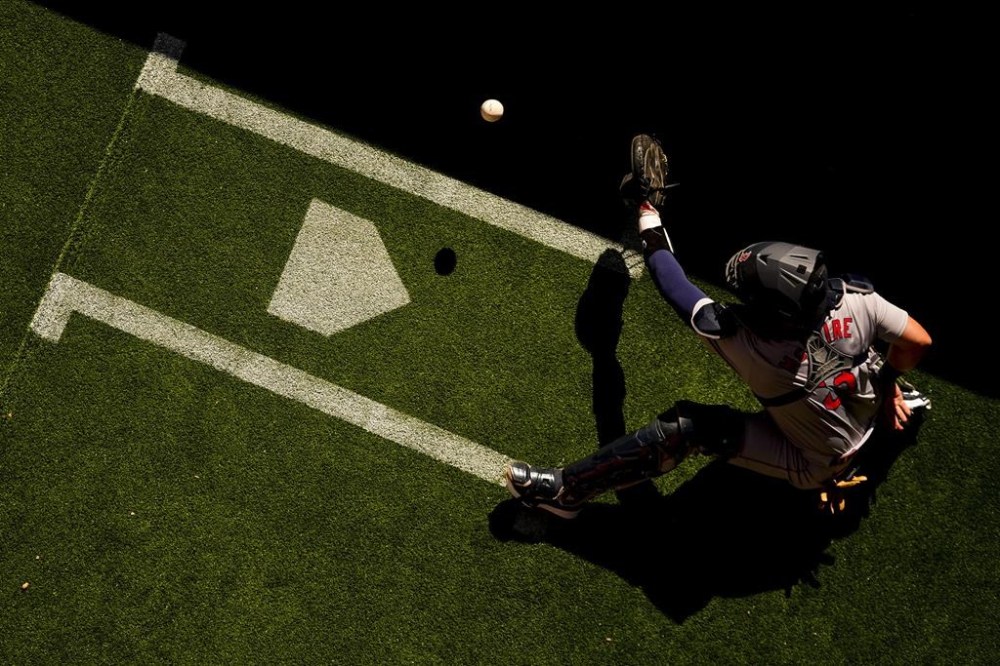 Boston Red Sox catcher Reese McGuire catches a ball in the bullpen while warming up before a baseball game against the Seattle Mariners, Sunday, March 31, 2024, in Seattle. (AP Photo/Lindsey Wasson)