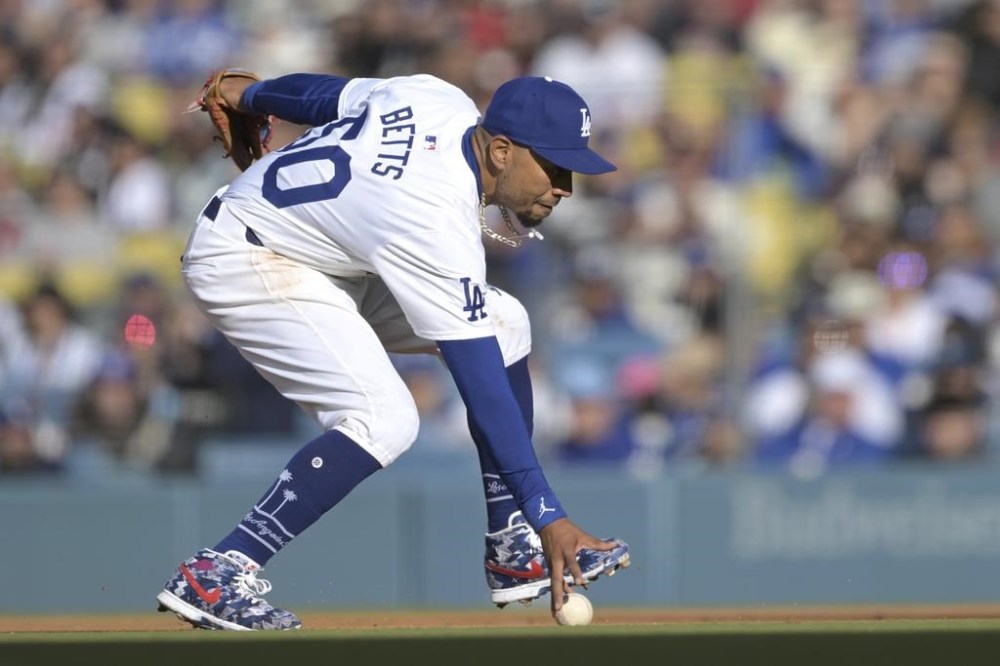 Los Angeles Dodgers second baseman can't field a ball hit by St. Louis Cardinals' Paul Goldschmidt during the fifth inning of a baseball game Sunday, March 31, 2024, in Los Angeles. (AP Photo/Jayne-Kamin-Oncea)