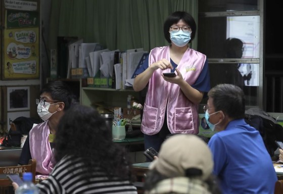 Moon Chen, a volunteer of Fake News Cleaner, guides students through the LINE app to identify fake news during a class in Kaohsiung City, southern Taiwan. (Chiang Ying-ying / The Associated Press files)
