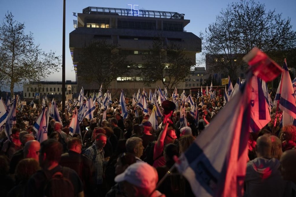 People take part in a protest against Israeli Prime Minister Benjamin Netanyahu's government and call for the release of hostages held in the Gaza Strip by the Hamas militant group outside of the Knesset, Israel's parliament, in Jerusalem, Sunday, March 31, 2024. Tens of thousands of Israelis gathered outside the parliament building in Jerusalem on Sunday, calling on the government to reach a deal to free dozens of hostages held by Hamas and to hold early elections. (AP Photo/Leo Correa)