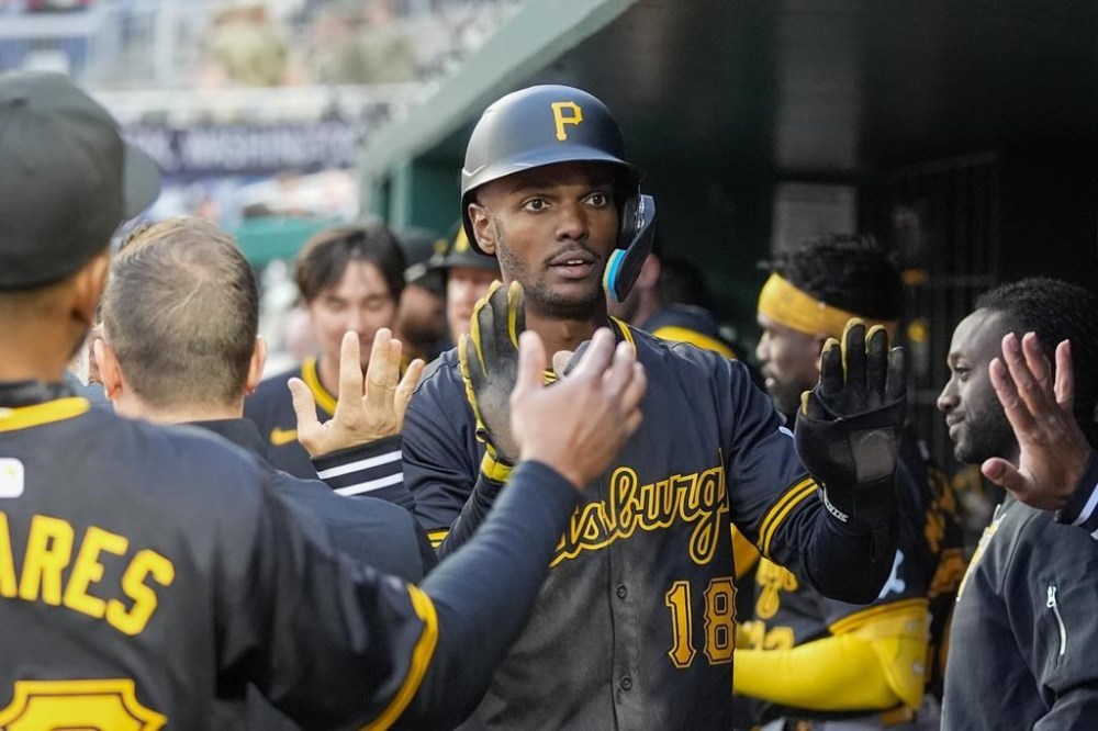 Pittsburgh Pirates' Michael A. Taylor celebrates scoring during the eighth inning of an opening-day baseball game against the Washington Nationals at Nationals Park, Monday, April 1, 2024, in Washington. ( AP Photo/Alex Brandon)