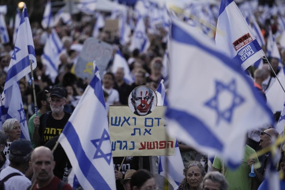 A placard depicting Israeli Prime Minister Benjamin Netanyahu is seen during a protest against Netanyahu's government and to call for the release of hostages held in the Gaza Strip by the Hamas militant group near the Knesset, Israel's parliament, in Jerusalem, Monday, April 1, 2024. (AP Photo/Leo Correa)