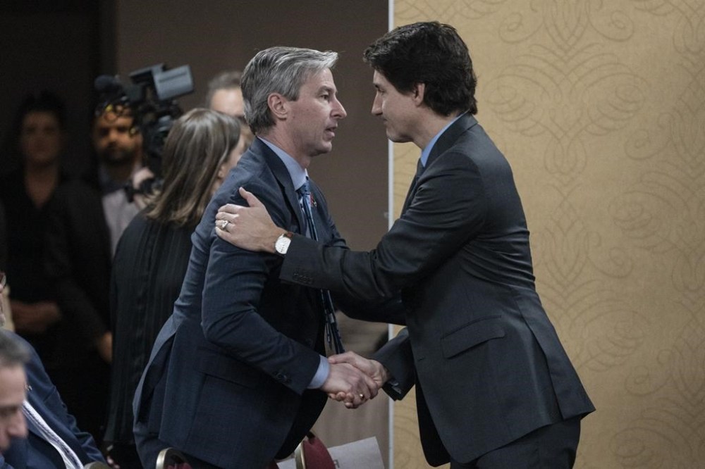 Prime Minister Justin Trudeau, right, is greeted by Nova Scotia Premier Tim Houston in Truro, N.S., on Thursday, March 30, 2023. Nova Scotia’s premier has responded to a challenge from the prime minister to submit an alternative to the federal carbon pricing program. THE CANADIAN PRESS/Darren Calabrese