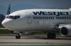 A WestJet Boeing 737-700 aircraft taxis to the runway for departure from Vancouver International Airport, in Richmond, B.C., on Friday, May 19, 2023. WestJet Encore pilots could go on strike as soon as April 17 after they approved a strike mandate Tuesday. THE CANADIAN PRESS/Darryl Dyck