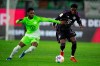 Wolfsburg's Ridle Baku, left, and Bayern's Alphonso Davies battle for the ball during the German Bundesliga soccer match between VfL Wolfsburg and Bayern Munich at the Volkswagen Arena, Wolfsburg, Germany, Wednesday, Dec. 20, 2023. Count the Vancouver Whitecaps among those watching Alphonso future with Bayern Munich with interest. The Whitecaps will benefit from any future sale, thanks to a sell-on clause negotiated in the Canadian star's sale to the German powerhouse in July 2018. THE CANADIAN PRESS/AP-Swen Pfortner/dpa via AP