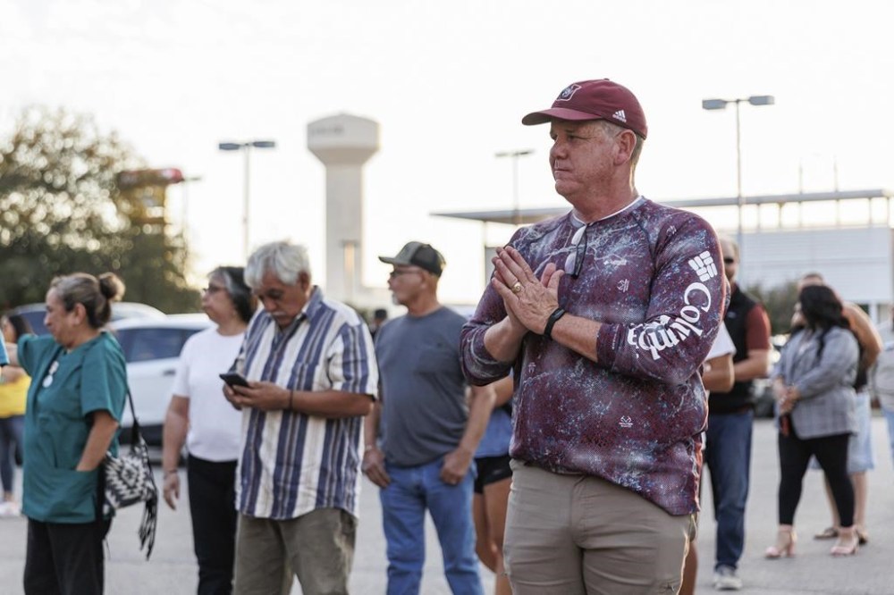 FILE - Uvalde mayoral candidate Cody Smith gestures toward a voter waiting in a long line outside of the SSGT Willie de Leon Civic Center on Election Day, Nov. 7, 2023, in Uvalde, Texas. On Monday, April 1, 2024, Smith, now mayor of Uvalde, resigned from his position effective immediately, leaving his post empty the same week the city's police chief is expected to step down. (Sam Owens/The San Antonio Express-News via AP, File)