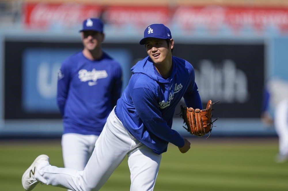 Los Angeles Dodgers designated hitter Shohei Ohtani warms up for the team's baseball game against the San Francisco Giants, Tuesday, April 2, 2024, in Los Angeles. (AP Photo/Ryan Sun)