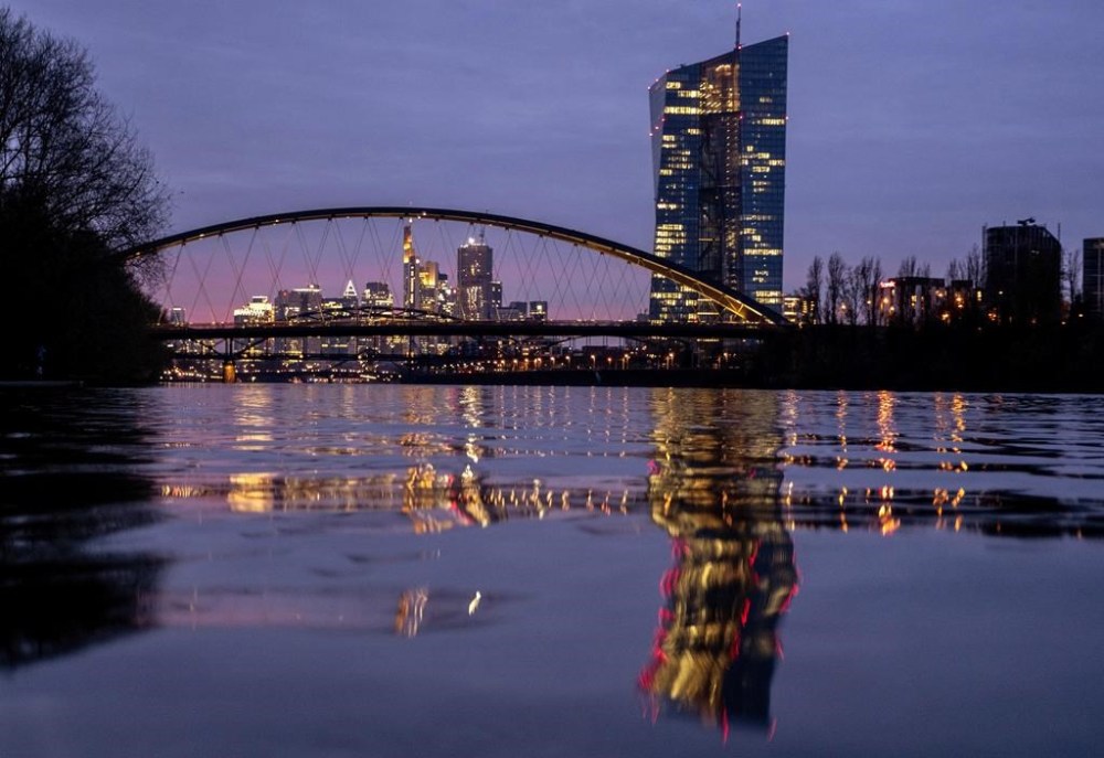 FILE - The European Central Bank is reflected in the river Main in Frankfurt, Germany, Thursday, March 21, 2024. The inflation that has squeezed European shoppers fell more than expected in March to 2.4%, as cost spikes in the grocery aisle eased and overall price rises headed down in the two biggest economies, Germany and France. (AP Photo/Michael Probst, File)