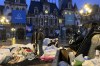 Migrants stand in front of the Paris City Hall, Wednesday, April 3, 2024. French police has removed about 50 migrants, including families with young children, from the Paris City Hall plaza as the capital prepares to mark 100 days to the start of the Olympic Games. (AP Photo/Nicolas Garriga)