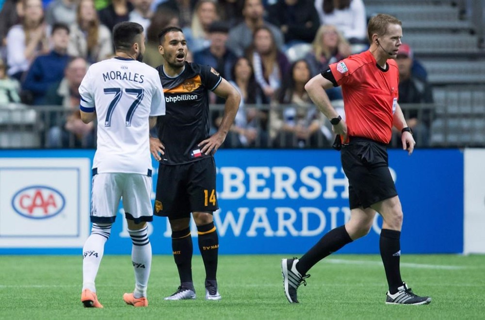 Houston Dynamo's Alex, second left, and Vancouver Whitecaps' Pedro Morales, left, react after both received red cards from referee Drew Fischer during the first half of an MLS soccer game in Vancouver on Saturday May 28, 2016. Canadian Fischer is one of 21 FIFA referees appointed to work the football tournament at this summer's Paris Olympics. THE CANADIAN PRESS/Darryl Dyck