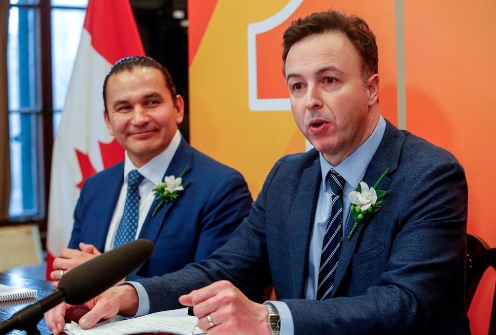 Manitoba Premier Wab Kinew and Finance Minister Adrien Sala speak to media before the provincial budget is read at the Manitoba Legislature in Winnipeg, Tuesday, April 2, 2024. The future of seven schools promised by the former Progressive Conservative government in Manitoba is uncertain. THE CANADIAN PRESS/John Woods.