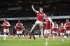 Arsenal's Martin Odegaard celebrates after scoring his side's opening goal during the English Premier League soccer match between Arsenal and Luton Town at the Emirates Stadium, London, Wednesday, Apr. 3, 2024. (AP Photo/Frank Augstein)